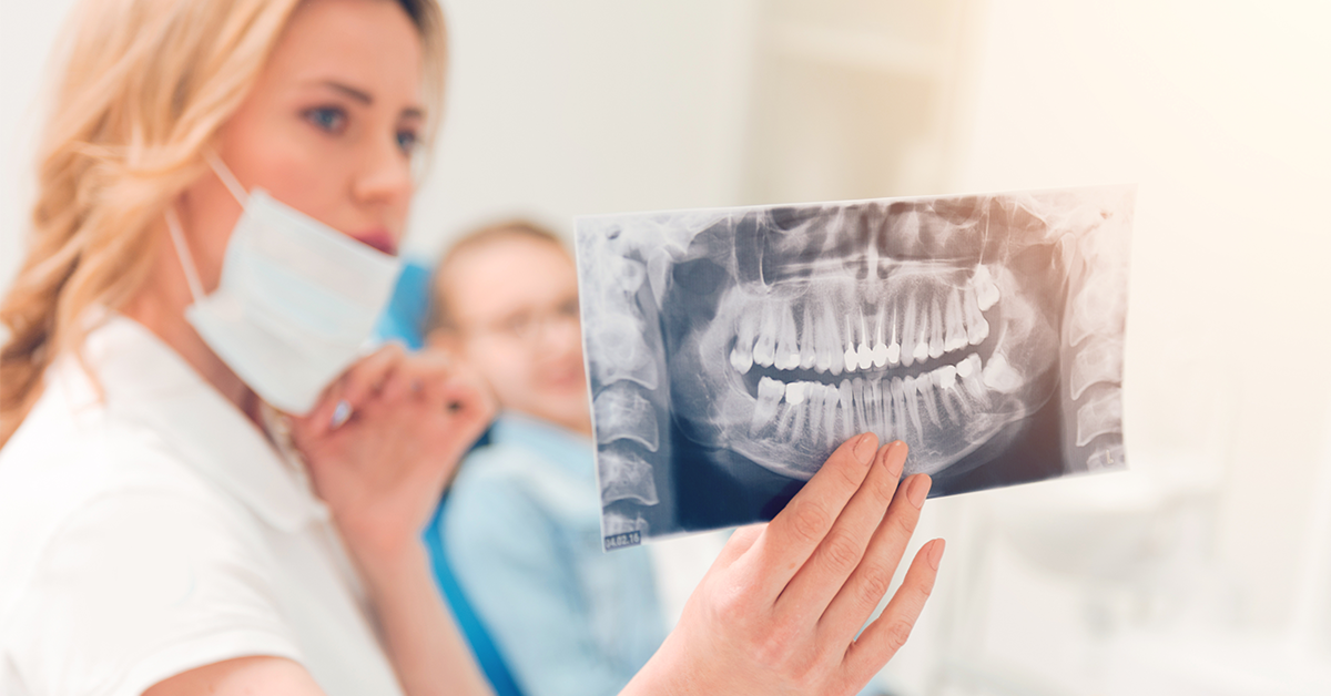 dental assistant explaining gum disease to patient